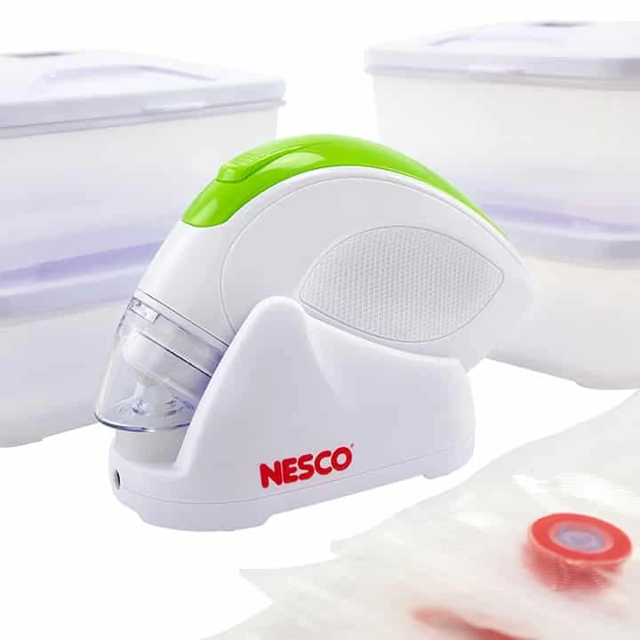 NESCO VS-09HHS2 white and green handheld pump in its charging stand